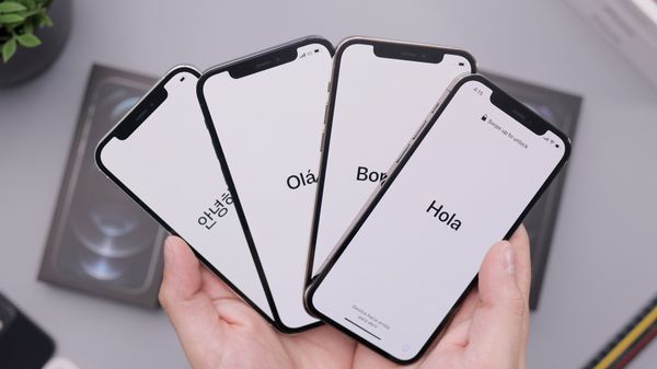 Four iPhones in someone's hands